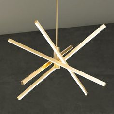 a chandelier hanging from the ceiling with wooden sticks sticking out of it's center