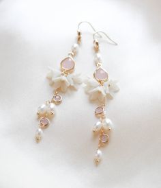 Be the belle of the ball with our SARINA earrings. Handcrafted in a long, intricate floral design, bejeweled with luscious freshwater pearls and pink opal stones, these earrings will make you sparkle like no other. With a sophisticated and artful design, you'll be chic and elegant on your special day. - Handcrafted in my studio in PA- Freshwater pearls- Polymer clay flowers- Yellow gold finish is pictured. Available in yellow gold or rhodium (silver)- Earrings measure 3.25 inches- Handcrafted in Delicate Pearl Drop Earrings With Flower Shape, Delicate Pearl Drop Earrings In Flower Shape, Delicate Flower Shape Pearl Drop Earrings, Elegant Pink Opal Jewelry For Formal Occasions, Elegant Formal Pink Opal Jewelry, Feminine Pink Pearl Drop Earrings, Elegant Rose Gold Pink Opal Jewelry, Pink Drop Flower Earrings For Formal Occasions, Pink Formal Flower Drop Earrings