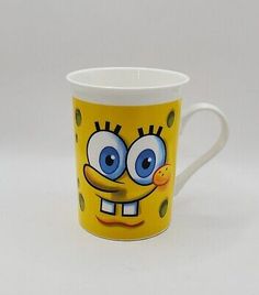 a yellow coffee cup with an angry face on it