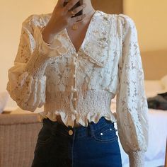 Lace button up shirt with long puff sleeves and a floral peter pan collar lined with pearl beads. Cinched waist and cuffs. Loop button closure. S: 13.5" across shoulders, 37" chest, 17" length M: 14" across shoulders, 38.5" chest, 17" length L: 14.5" across shoulders, 40" chest, 17.5" length XL: 15" across shoulders, 41.5" chest, 17.5" length Spring Long Sleeve Blouse With Lace Collar, Spring Blouse With Lace Collar And Long Sleeves, Spring Chic Blouse With Pearl Buttons, Spring Blouse With Lace Collar And Lantern Sleeves, Long Sleeve Blouse With Pearl Buttons, Spring Button-up Blouse With Lace Collar, Spring Fitted Blouse With Doll Collar, Fall Long Sleeve Blouse With Pearl Buttons, Long Sleeve Blouse With Pearl Buttons For Fall