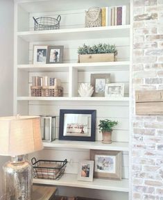 a living room filled with lots of white shelves