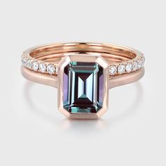 a rose gold ring with an emerald and diamonds