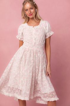 Expertly crafted, the Esmee Dress in Floral offers a delicate white base with a stunning floral lace overlay. The round neckline framed with eyelet trim adds a touch of elegance, while the elastic waistband offers a comfortable and flattering fit. Functional buttons and a knee-length skirt make it both stylish and prac White Feminine Floral Dress With Smocked Bodice, White Floral Dress With Smocked Bodice, Feminine Floral Dress With Smocked Back For Daywear, Modest Sundress, Starry Night Dress, Modest Dresses For Women, Ivy City Co, Lover Dress, Lacey Dress