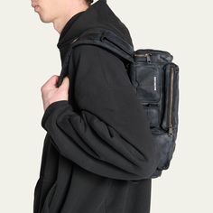 Balenciaga "Superbus" sling bag in distressed nylon Shoulder strap with a logo-engraved hook; 11" drop Logo embossed on the front Two-way zip closure BB logo engraved zip pull Exterior, two pockets on the strap, two front zip pockets, one front earpods compartment, one front card holder, one side flap pocket, one side zip pocket, one back zip pocket, one back hook Cotton canvas lining Aged-gold hardware Approx. 5.1"H x 14.5"W x 4.7"D... Streetwear Shoulder Chest Bag With Zipper Closure, Leather Shoulder Bag For Streetwear With Zipper, Streetwear Crossbody Chest Bag With Zipper Pocket, Streetwear Shoulder Chest Bag With Zipper Pocket, Functional Leather Bags For Streetwear, Streetwear Chest Bag With Zipper Pocket, Streetwear Chest Bag With Zipper, Utility Bags With Functional Pockets For Streetwear, Streetwear Crossbody Chest Bag With Zipper Closure