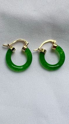 Add a touch of timeless elegance to your collection with our stunning Jade Hoop Earrings. Handcrafted with care, these earrings are perfect for any occasion. Don’t miss out on our limited-time offer – enjoy 25% off on your purchase at our Etsy shop. Elevate your style today with these beautiful jade hoops! #etsyseller  #etsyfinds  #etsyjewelryshop  #jewelryaddict  #jewelrytrends  #giftsforher  #shopsmall  #925sterlingsilver  #giftsforher  #earringsoftheday #bohochic  #ringsjewelry  #stackablerings  #stacking  #daintyjewelry #jade #sale  #jewelryaesthetic #earringsoftheday  #earrings #earringstyle Green Jade Earrings For Pierced Ears, Elegant Jade Hoop Earrings, Elegant Green Huggie Jewelry, Jade Hoop Earrings For Gift, Green Jade Earrings For May Birthstone, Small Hoop Green Earrings For May Birthstone, Green Round Earrings For May Birthstone, Green Earrings For May Birthstone, Single Green Round Earring