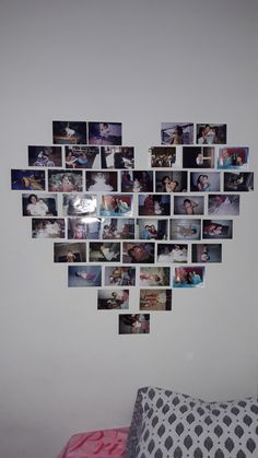 a heart shaped photo collage hanging on the wall next to a bed with pink sheets