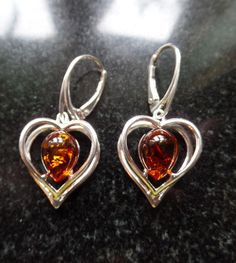 Overseas Buyers, can you please include a Mobile Phone number for the Courier for tracking updates.Follow me on Instagram to see my latest listings Sterling Silver and Baltic Cognac Amber 3 Dimensional Heart Earrings with Lever back closure. Fab modern design. Amber is the Birthstone for Taurus and is considered a Lucky Stone Measures 1.71cm wide by 3.66cm to the top of the Fitting. The Weight is 4.8g (2.4g each) Shipping includes a Gift Box, made in England, using recycled Card and Paper. Item Taurus Birthstone, Amber Heart, Lucky Stone, Baltic Amber, Heart Earrings, Phone Number, Cognac, Favorite Jewelry, Birthstone