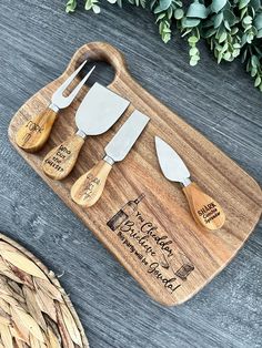 three wooden utensils sitting on top of a cutting board