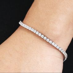 This elegant moissante tennis bracelet features a row of moissanite set in a pure 14k/18k gold chain. The bracelet makes the perfect bracelet for your everyday use, bridal gifts, and weddings. The bracelet is stamped with 14/18K gold mark and is a beautiful piece for this price. Bracelet Details: Bracelet Width: 3mm Metal Type: Solid 14K/18K Gold Metal Color: Can be made with Rose Gold (RG), Yellow Gold (YG), or White Gold (WG). Moissanite Total Carat: 4.5 carats Moissanite Color: E-F Moissanite White Moissanite Tennis Bracelet For Weddings, White Moissanite Tennis Bracelet As Gift, White Tennis Bangle Bracelet With Prong Setting, Flexible Diamond White Cubic Zirconia Tennis Bracelet, White Moissanite Fine Jewelry Tennis Bracelet, White Moissanite Tennis Bracelet, White Flexible Tennis Bracelet As Gift, Flexible White Tennis Bracelet As A Gift, Flexible White Tennis Bracelet For Gift