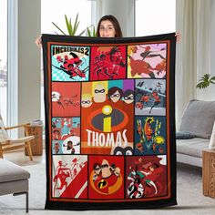 a woman holding up a blanket with the words, incredibles and superheros on it