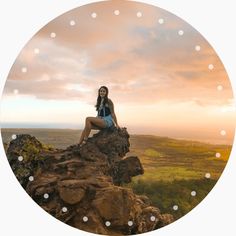 a woman sitting on top of a large rock