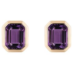 These Amethyst Emerald Cut Bezel Set Stud Earrings in 18K Yellow Gold, part of the exquisite 'Manhattan' Collection, are a stunning embodiment of timeless elegance. These earrings feature rich amethyst gemstones with a striking emerald-cut design, securely encased in a lustrous 18K yellow gold bezel setting. The combination of the deep purple amethyst and warm yellow gold exudes a luxurious charm, making these earrings a perfect accessory for any sophisticated occasion. With their classic yet co Emerald Cut Stud Earrings, Amethyst Studs, Emerald Earrings Studs, Warm Yellow, Purple Earrings, Fine Jewelry Designers, Amethyst Earrings, Contemporary Jewelry, Amethyst Stone