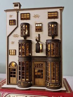 a doll house is shown on top of a book