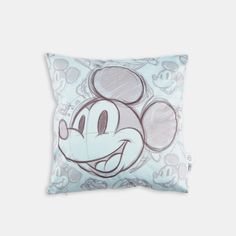 a mickey mouse pillow sitting on top of a white wall