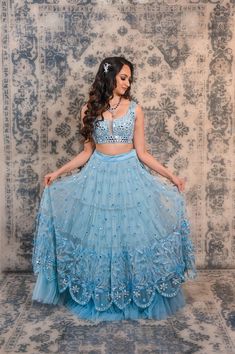 Nail the simplistic look by wearing this powdered blue mirror and sequins work lehenga Lehenga is one of the comfiest staples that has gained much more popularity and perfectly fits into wedding occasions. This beautiful powdered blue coloured lehenga is great for all the new age beauties. This lehenga is a perfect combination of a traditional statement and a modern twist. The skirt of this lehenga is smart and light which will make all girls go head over heels. The bottom of the skirt is comple Blue Hand Embellished Lehenga For Party, Blue Hand Embellished Sharara For Reception, Designer Blue Choli With Sequins, Blue Hand Embellished Choli For Reception, Designer Blue Sequined Choli, Blue Sequined Lehenga For Navratri, Blue Sequined Lehenga For Diwali, Blue Sequined Lehenga For Festive Occasions, Festive Blue Sequined Lehenga