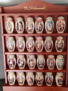 there is a shelf that has many different jars on it, including jesus and mary