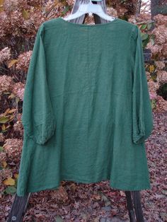 This Linen Deep V Single Button Cardigan is from a Spring Collection in Jade in Perfect Condition Made from a Light Weight Linen ~ The Features a Refreshing Deep V Shaped Neckline accented by a Single Button Closure ~ An Empire Waist Seam Both Front and Back ~ Pinched Billowy Three Quarter Length Sleeves Accented in Elastic Edges~ An Open Vented Front with a Varying A Line Flair ~ An A Line Shape and Comes Unpainted with a slightly Smaller Waistline Measurement. The Measurements are as Follows: Lagenlook Long Sleeve Top With Buttons, Green Buttoned Cardigan For Layering, Green Buttoned Top For Layering, Bohemian Green Tops With Buttons, Fall Linen Top With Buttons, Bohemian Tops With Button Cuffs And Long Sleeves, Green Tunic Top For Fall, True Winter, Magnolia Pearl