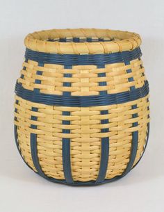 a blue and yellow basket sitting on top of a table