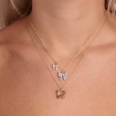 14k yellow gold and diamond bow charm featuring some of our most iconic icons. The charm measures appx. 1/2"W x 1/2"H. Fine 14k gold medium ball chain is available in 16" or 18" lengths. Yellow Gold Pendant Charm Necklace For Party, Gold Charm Necklaces With Diamond Accents In 14k Gold, Party Yellow Gold Pendant Charm Necklaces, Party Yellow Gold Pendant Charm Necklace, Luxury 14k Gold Charm Necklaces, Elegant Diamond Charm Necklace, Luxe Necklace, Gold Ball Chain, Diamond Charm Necklace