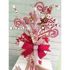 a candy cane arrangement in a gift box