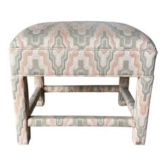 an upholstered foot stool with geometric patterns