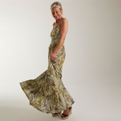 an older woman in a long dress posing for the camera with her hand on her hip