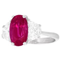 Circa 1990s, 18k, American. This stunning ruby and diamond ring features a spectacular 3.38-carat Vietnamese ruby set with 2 superb white diamonds (1.40cttw H color, VS clarity). The ruby comes with a GIA laboratory report stating Vietnamese origin and presence of minimal heat. Vietnamese rubies are rare and particularly beautiful. Exquisitely made, this ring is in excellent condition. Remark: "The intense color and striking size of the ruby is captivating!” SIZE: 7 1/4, it can be sized. WEIGHT: 3.8 grams STONES: 3.38 carat low heat antique Vietnamese ruby (GIA report) and 1.40 carats total weight of H color, VS clarity diamonds HALLMARKS: 18k STOCK NUMBER: 25931 Jewelry acquired from this dealer must delight you. Purchases may be returned for any reason for a period of 7 days. Ruby Set, Ruby And Diamond Ring, Vintage Cocktail Ring, Marquise Ring, Retro Ring, Ruby Pendant, Diamond Cocktail Rings, Ruby Stone, Modern Ring