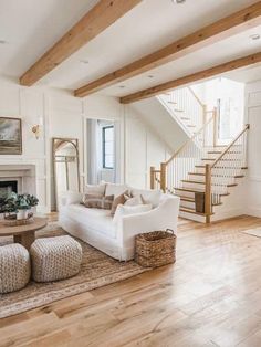 a living room filled with furniture and a fire place next to a stair case in front of a fireplace