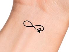 a dog's paw with an infinite sign tattoo on it