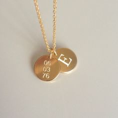 "Beautiful and charming, this double gold disc necklace is simple yet stunning. I diamond etch engrave your initial on one charm and a date on the other. Each disc charm is made from 14k gold fill and is approximately 12.5mm in diameter. A sturdy 14k gold fill chain and spring ring clasp is used. Please make sure to select your desired length in the drop down menu. In addition, please make sure to let me know what initial and date you would like to have engraved in the \"note to seller\" field u Minimalist Name Necklace With Charms For Anniversary, Everyday Gold Nameplate Charm Necklace, Everyday Gold Nameplate Charm Necklaces, Gold Name Necklace With Round Charms Pendant, Personalized Gold Necklaces For Anniversary Gift, Minimalist Stamped Round Disc Necklaces, Minimalist Stamped Round Disc Necklace, Gold Charm Name Necklace For Anniversary, Gold Name Necklace With Charms For Anniversary