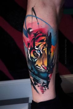 a colorful tiger tattoo on the left arm and leg, done by an expert in body art