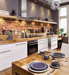 the kitchen is clean and ready to be used for dinner or lunchtime, with dishes on the table