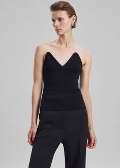 Color: Black Knitted stretch fabric Bustier top V neckline Strapless Fitted waistline Slip-on style Unlined 63% Viscose 27% Polyetser 9% Polyamide 1% Elastane Hand Wash By Coperni. Made in Italy Cami Top With Built-in Bra For Evening, Chic Fitted V-neck Crop Top, Chic Bandeau Crop Top In Elastane, Chic Bandeau Crop Top, Stretch Knit Top For Evening, Chic Seamless Elastane Tube Top, Elegant Fitted Elastane Tube Top, Elegant Fitted Camisole With Built-in Bra, Chic Elastane Cami Crop Top