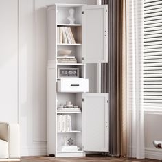 a white bookcase in the corner of a room