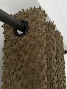 a close up of a piece of burlocked material hanging on a wall