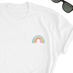 Rainbow Shirt, Cute Rainbow T-Shirt, Rainbow Cute shirt, Happiness Cute T-shirt, Summer Lover Tee, Optimism Lover Clothing, Rainbow Cute Top, UNISEX This t-shirt feels soft and lightweight, with the right amount of stretch. It's comfortable and flattering for both men and women. * 100% cotton (heather colors contain polyester) * Fabric weight: 5 oz * Shoulder-to-shoulder taping * Side-seamed Time for Delivery: * Processing & production time is 1-6 business days (usually 2-3 days). * U.S. Shi Trendy Cotton T-shirt With Rainbow Print, Rainbow Print Cotton T-shirt With Short Sleeves, Casual Rainbow Print Short Sleeve T-shirt, White Cotton T-shirt With Rainbow Print, Casual Short Sleeve T-shirt With Rainbow Print, Trendy Rainbow Short Sleeve T-shirt, Fun Rainbow Print Short Sleeve Top, Cute Multicolor T-shirt With Rainbow Print, Cute Multicolor Rainbow Print T-shirt