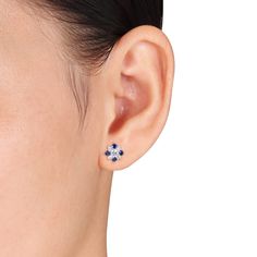 These splendid stud earrings are crafted in 14-karat white gold and feature a flower shaped stud with petals of blue and white sapphire stones. Coordinate these colorful and versatile earrings with any ensemble from business casual to formal wear. Engraved Bangle Bracelet, Filigree Hoop Earrings, Sapphire Earrings Studs, White Gold Studs, White Gold Earrings Studs, Sapphire Studs, Solitaire Earrings, Floral Studs, Blue Topaz Earrings