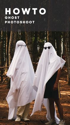 two people dressed in white standing next to each other on a dirt ground with trees behind them