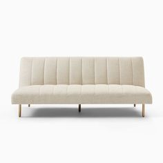 a white couch sitting on top of a wooden frame