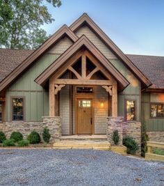 a large house with stone and wood trimmings on the front door, windows, and entry way