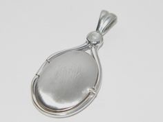 "Handcrafted Locket Pendant , made of Solid pure .925 Sterling Silver . The Pendant is encrusted with one gentle 4 mm Genuine Natural Rainbow Moonstone . High quality Hand polished without scratches as cheap jewelry and front Satin Finished . The Natural Rainbow Moonstone are stunning,and the Solid .925 Sterling Silver is plated Rhodium. The Rhodium plating (bonding)is achieved using an electroplating process that coats the item with heavy layers of Rhodium(a close cousin of platinum that costs Silver Round Cabochons With Polished Finish, Silver Jewelry With Polished Oval Cabochon, Silver Oval Cabochon Jewelry For Anniversary, Oval Silver Cabochons For Gift, Round Polished Cabochons As Gifts, Round Polished Cabochons For Gifts, Oval White Gold Cabochons For Gift, Silver Oval Cabochon Locket Jewelry, Moonstone Locket