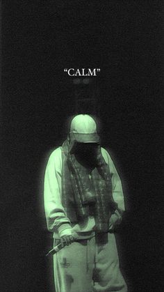 a man standing in front of a black background with the word calm on it's face