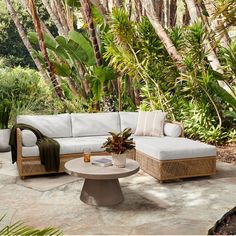 an outdoor living area with couches and tables