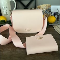 Nwot Pink Kate Spade Madison Saffiano Leather Saddle Bag And Lelia Medium Compact Bifold Wallet. Wallet And Purse Are The Same Pale Pink Color - Perfect Matching Set. Bought And Removed Tags But Realized It’s Too Small For What I Need. My Loss Is Your Gain! Bag 6” H X 3.2” D X 8.2” W Strap Drop 24” At Longest Flap With Magnetic Snap Closure Back And Front Slip Pockets Wallet 4.5” H X 5.5” W X 1” D Pebbled Leather 8 Credit Card Slots, Id Window, 4 Slip Pockets, 2 Billfolds And 1 Zip Coin Compartm Kate Spade Evening Bags With Card Slots, Chic Bifold Leather Bag, Kate Spade Formal Bags With Card Slots, Chic Leather Bifold Bags, Kate Spade Everyday Bifold Bag, Blush Bag With Card Slots, Classic Kate Spade Bags With Card Slots, Pink Leather Bifold Bags, Kate Spade Bags With Card Slots For Gift