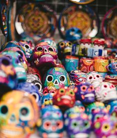 there are many colorful skulls on display for sale