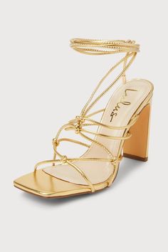 The Lulus Rinay Gold Strappy Lace-Up High Heel Sandals are exactly what your going-out 'fits have been missing! Shiny faux leather shapes these flirty heels that feature a trendy square footbed and single sole silhouette. Knotted ties create a strappy upper that houses long laces (with gold aglets) that wrap around and tie above the ankle. A sleek blade heel completes the look! 4" wrapped blade heel. Cushioned insole. Rubber sole has nonskid markings. Man made materials. Imported. Lulus | Rinay Gold Strappy Lace-Up High Heel Sandal Heels | Size 5. Heels For Long Dresses, Light Gold Heels, Gold Lace Up Heels, Gold Heels Prom, Homecoming Heels, Golden Heels, Wrap Around Heels, Homecoming Freshman, Dress Up Shoes