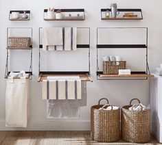 towels and baskets are hanging on the wall