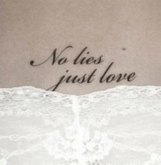 a tattoo saying no lies just love on the back of a woman's stomach