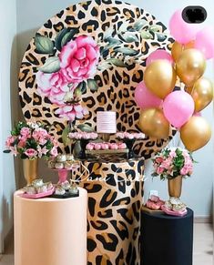 a leopard print chair with pink and gold balloons