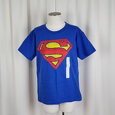 Superman Classic Logo T Shirt Royal Color: Royal Blue Size: S Fit: Classic Pit To Pit: 15.4“ Approx Sleeve Length: 5.4 “ Approx Length: 20.0“ Approx Material: 100% Cotton Care: Machine Wash Cold Description: Superman Logo Printed Across The Front, Crew Neck Style, Short Sleeve Condition: New, Tags Have Fallen Off But Will Be Included, Smells Very Flowery, Creases From Storage Kc81j5 Blue Superhero T-shirt With Character Print, Blue Superhero Short Sleeve Top, Blue Short Sleeve Superhero Tops, Blue Superhero Crew Neck Top, Superman Boy, Wonder Woman Shirt, Long Tshirt Dress, Dc Comics Shirts, Dc Comics Girls